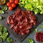 Sliced Prosciutto With Pomegranate Seeds